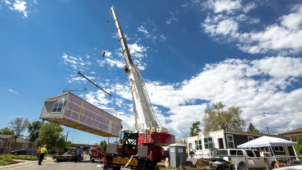 A piece of a modular housing unit arrives to a project on land provided by the Colorado Community Land Trust in Elyria Swansea. Aug. 12, 2020.