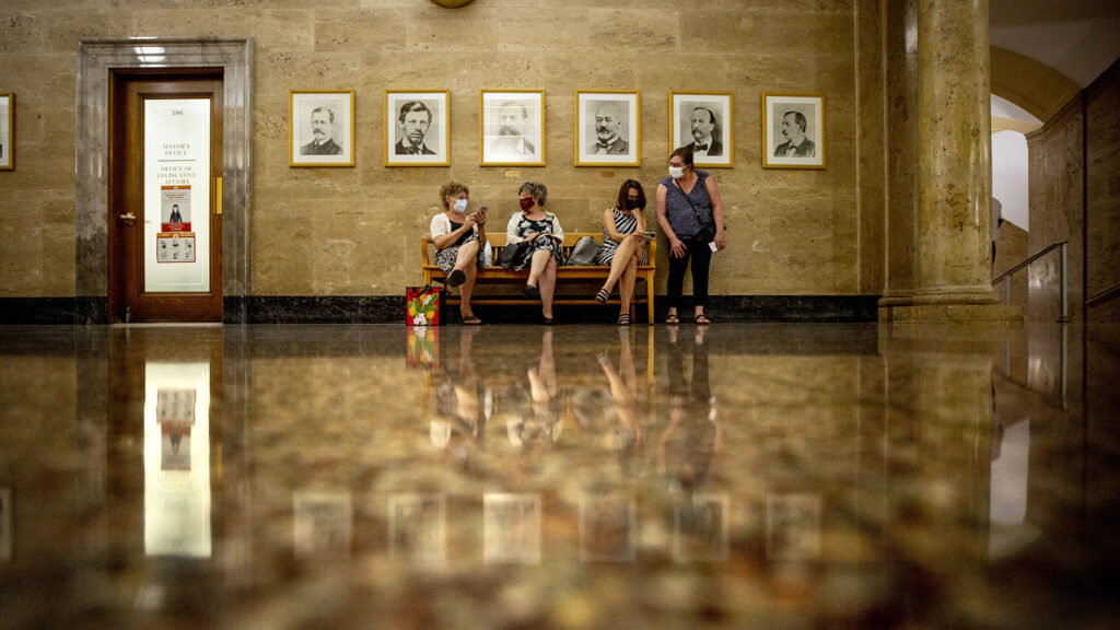 Donna Drebenstedt (left to right),
Barbara Lencicki, Paige Burkeholder and Debra Armento listen to a Denver Planning Board public hearing about changes to group living rules. They came out to oppose the changes. Aug. 19, 2020.