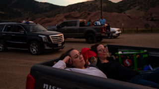 Nikkol Grimes, left, and Sonja Taylor relax while watching Grease during the 21st annual Film on the Rocks, drive-in edition at Red Rocks Park on Aug. 13, 2020. Grimes is a Grease fanatic who says she’s probably seen the classic movie 50 times.