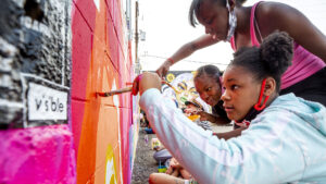 Jasmine (left to right), Jadah and Jordan Ward paint a wall during CRUSH Walls 2020 outside of Denver Central Market on Larimer Street. Sept. 18, 2020.