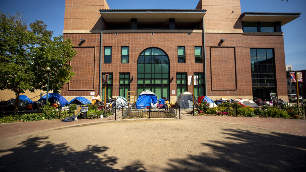 An encampment along the side of the Blair-Caldwell African American Research Library on Welton Street in Five Points. Sept. 30, 2020.
