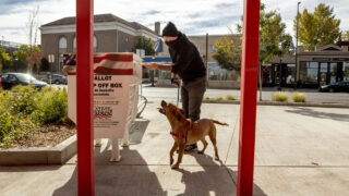 Hank Murphy and Deedee cast a ballot for the November 2020 election outside of the Carla Madison Rec Center on Colfax Avenue. Oct. 16, 2020.