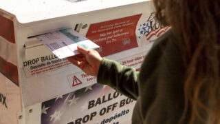 Samantha Rhodes completes her civic duty for the November, 2020 election outside of the Carla Madison Rec Center on Colfax Avenue. Oct. 16, 2020.