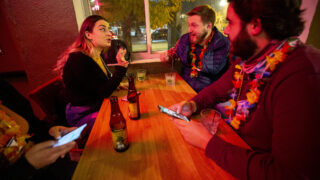 Monica Raimondi, who's visiting from Chicago, chats with New Yorkers Neil Parrello and Marshall Dickerson during a Denver Pub Crawl stop at El Chapultepec. Oct. 23, 2020.