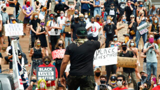 Terrance Robertsts leads protesters in chants calling for an end to police violence on the steps of the Colorado State Capitol in Denver, July 19, 2020.