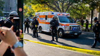 An ambulance leaves the scene after a soup drive and "anti-fascist" protest clashed with pro-police "patriot" protestors, ending in one person being shot on October 10, 2020 at Civic Center Park.