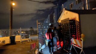 Susana Perez, Alex Call and Cody Goeken enter a "No Place to Go " installation by artists Emily Marie Passos Duffy & Michaela Mujica-Steiner.