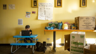 Pan (6) at work for virtual first grade inside her parents' restaurant, J's Noodle and Star Thai Delivery, on Federal Boulevard. Nov. 10, 2020.