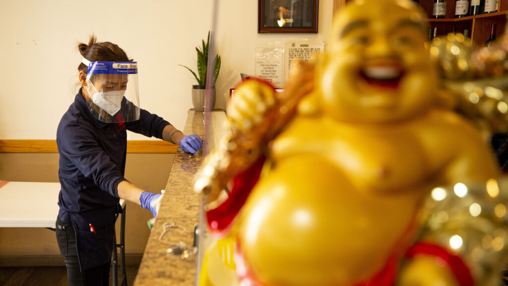Lisa Xu, manager of Star Kitchen on Federal Boulevard, cleans the front of house on Nov. 10, 2020.