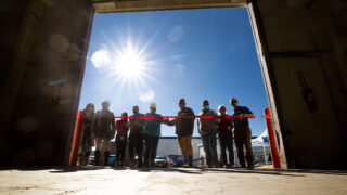 Mile High Behavioral Healthcare workers and their supporters cut the ribbon on a warehouse that will become an emergency homelessness shelter in Aurora. Nov. 11, 2020.