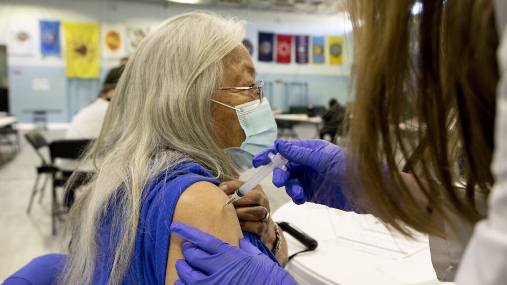 Gina Cammarata gets the first round of a Moderna COVID-19 vaccine at the Denver Indian Center, part of the second wave of prioritized shots in the city. Jan. 8, 2020.