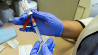 Medical assistant Yasmin Tellez preps a Modetna COVID-19 vaccination at Globeville's Clinica Tepeyac. Jan. 26, 2021.