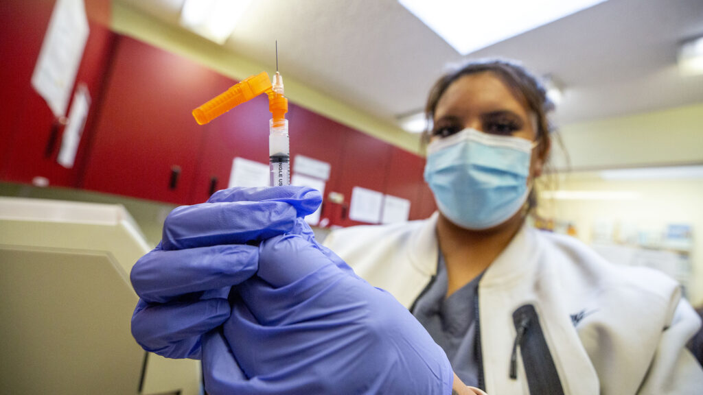 Medical assistant Yasmin Tellez preps a Modetna COVID-19 vaccination at Globeville's Clinica Tepeyac. Jan. 26, 2021.