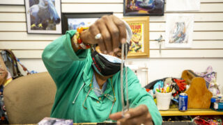 Jackie Logan works to sell everyting at Neat Stuff on Welton, on the 2500 Block of Welton Street, before she closes up shop for good. Feb. 8, 2021.