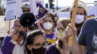 Candice Vigil, who helps Mental Health Center of Denver clients get work in foodservice, pickets with colleagues and supporters along Federal Boulevard for higher and more predictable wages. Feb. 20, 2021.