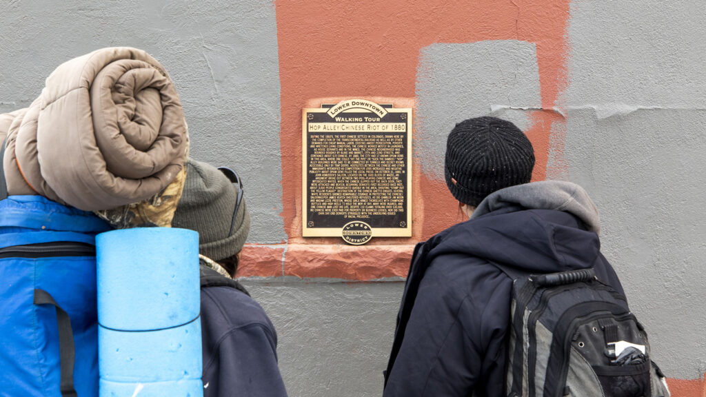 A historic marker in LoDo that details the "Chinese Riot of 1880." Feb. 25, 2021.