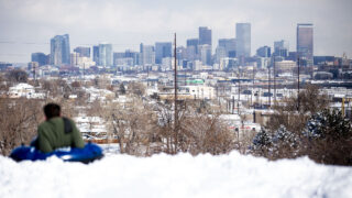 Grayson Goodman gazes out at the city on a break from tubing Denver's Ruby Hill. Feb. 25, 2021.