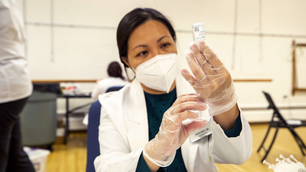 Nhung Mai draws out a COVID-19 vaccine at a city-run clinic inside the Barnum Recreation Center. March 10, 2021.