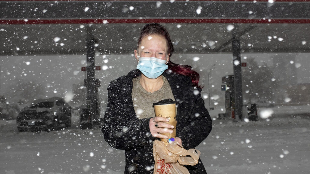 Christy Johnson stands in the snow outside of a Montbello gas station. March 14, 2021.