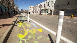 The driving space on Santa Fe Drive was recently slimmed in favor of more room to walk and roll by its galleries. April 9, 2021.