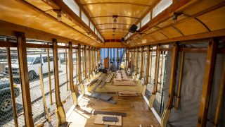 Dave Muggli rehabs some rotten floorboards in the old Denver Trolley, which has sat outside by Confluence Park for three decades. April 22, 2021.