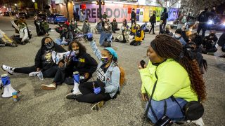 Protesters led by Aariyah Johnson (left to right), Rahma Ahmed, Ashira Campbell and Iris Butler hold the intersection of Colfax Avenue and Washington Street for ten minutes. April 23, 2021.