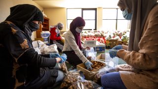 Safa Hama, Sarah Alruwayi and Etaf Alghunaim fill bags with dates during a Ramadan food drive at the Colorado Muslim Society on Parker Road. April 10, 2021.