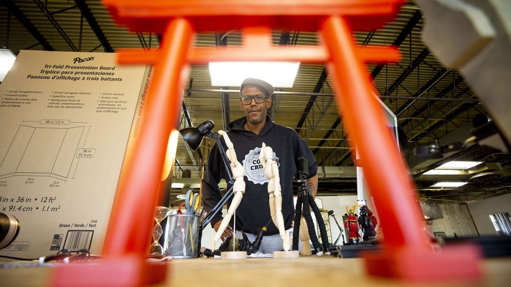 Musa Bailey stands above some of the miniatures he's using for a stop motion animation project. May 20, 2021.