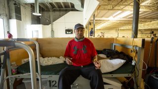 Wiley Brown sits on his bed inside the Salvation Army's Crossroads shelter off Brighton Boulevard in Five Points. May 20, 2021.