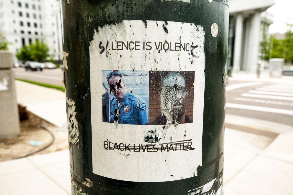 "SILENCE IS VIOLENCE," pasted to a light pole on Broadway by the Colorado State Capitol. May 27, 2021.
