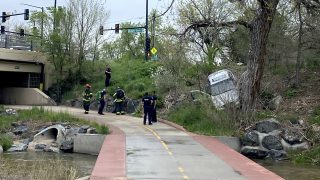 Police and fire crews on the scene of a car crash on the Cherry Creek Trail, where people regularly walk and bike.