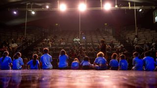 Kids from Cleo Parker Robinson Dance's STREAM Theatre and Creative Academy programs sit on stage in the main theater space. June 11, 2021.