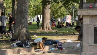 People hang out in Civic Center Park. July 10, 2021.