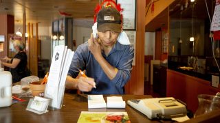 Jiarong Wang, owner of JJ Bistro, takes a call-in order around lunchtime. July 12, 2021.