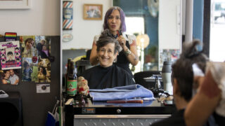 Cue Perez, owner of Babooshka hair salon on East Colfax Avenue, works on Diane D'Angelo's hair on a Saturday morning. July 24, 2021.