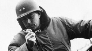 Major General Maurice Rose, Commanding General of the 3rd Armored Division, radios from his jeep in Cologne, Germany, March 6, 1945.