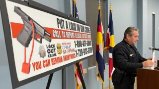 Denver Police Chief Paul Pazen stands next to a billboard encouraging people to report gun crimes following a press conference on Wednesday, July 28, 2021. (Esteban L. Hernandez/Denverite)