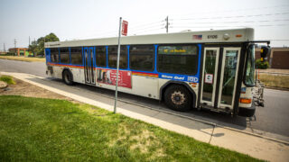 An RTD bus pulls away from a stop on 47th Avenue in Montbello. Aug. 10, 2021. JoyAnn Keener Ruscha.