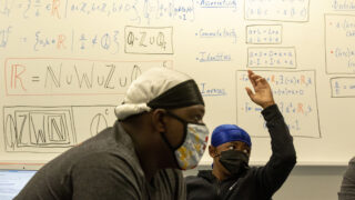 Steve Griffin raises his hand in Najja Shakir Al-Islam's classroom on the inaugural first day of school at Robert F. Smith STEAM Academy. Aug. 23, 2021.