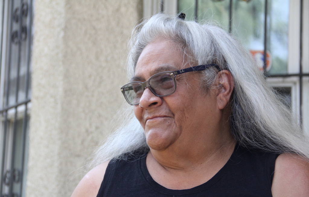 Cathy Prieto poses for a photo outside her home on Lipan Street in the Lincoln Park neighborhood on Monday, August 2, 2021. (Esteban L. Hernandez/Denverite)
