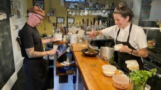 Chefs Royce Oliveira and Chelsea Schumacher work dinner service at To the Wind Bistro on August 4, 2021. Rebecca Spiess/Denverite