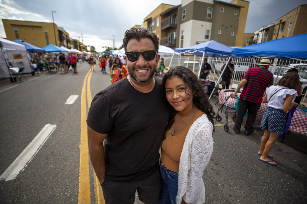 Denver Clerk and Recorder Paul Lopez stands on Morrison Road with his daughter, Nayeli, during the Westwood Chile Fest. Sept. 11, 2021.