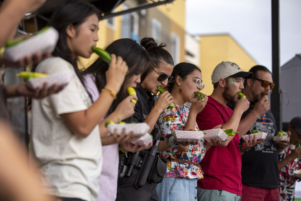 Contestants down spicy chiles during an eating contest at the Westwood Chile Fest. Sept. 11, 2021.