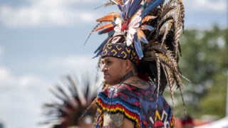 Santiago Jaramillo, a member of Kalpulli Tepeyollotl, performs an indigenous Aztec dance on Morrison Road during the Westwood Chile Fest. Sept. 11, 2021.
