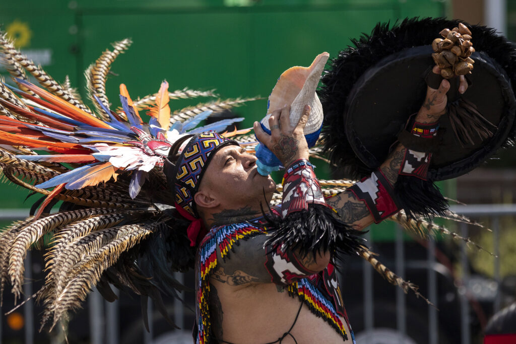 Santiago Jaramillo, a member of Kalpulli Tepeyollotl, blesses the land around Morrison Road before an indigenous Aztec dance during the Westwood Chile Fest. Sept. 11, 2021.