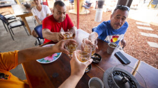 Boogie Down owner Ron Martinez (right) and Ed Martinez cheers a reporter on Boogie Down's Morrison Road patio. Sept. 13, 2021.