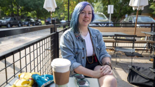 Emily Wells hangs out on the Honey Hill Cafe's patio in North Park Hill. Sept. 29, 2021.