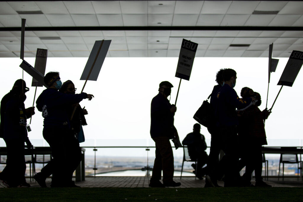 Members of the Service Workers International Union picket for higher wages at Denver International Airport. Oct. 1, 2021.