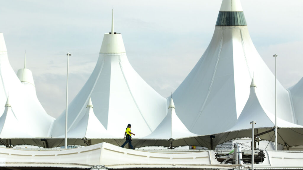 A guy walks on a roof outside of Denver International Airport. Oct. 1, 2021.