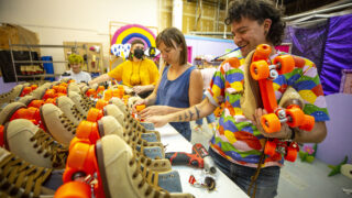 Frankie Toan (right) helps change roller skate wheels in Rainbow Dome's Valverde workshop. Oct. 5, 2021.